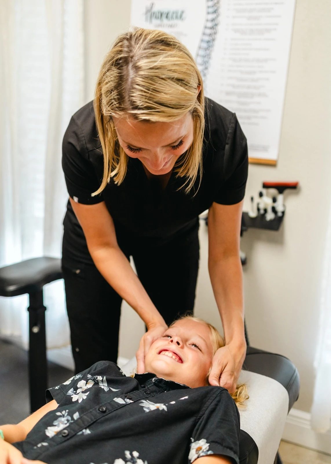 A gentle chiropractic adjustment for a young patient at Grace Medical and Chiropractic