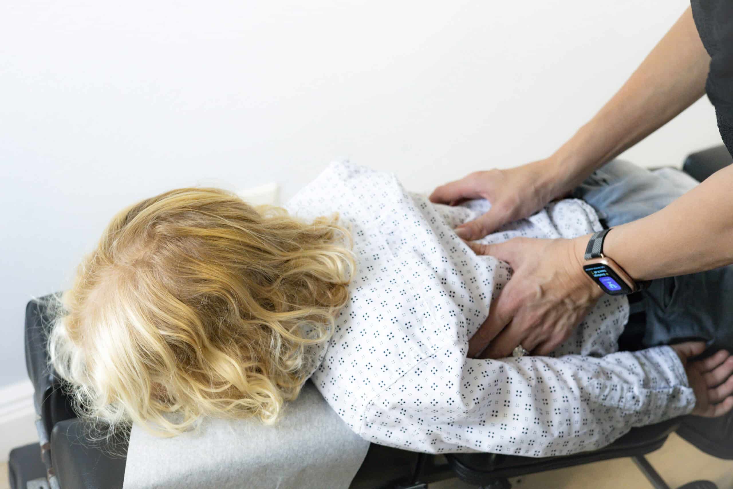 Patient receiving chiropractic adjustment at Grace Medical clinic